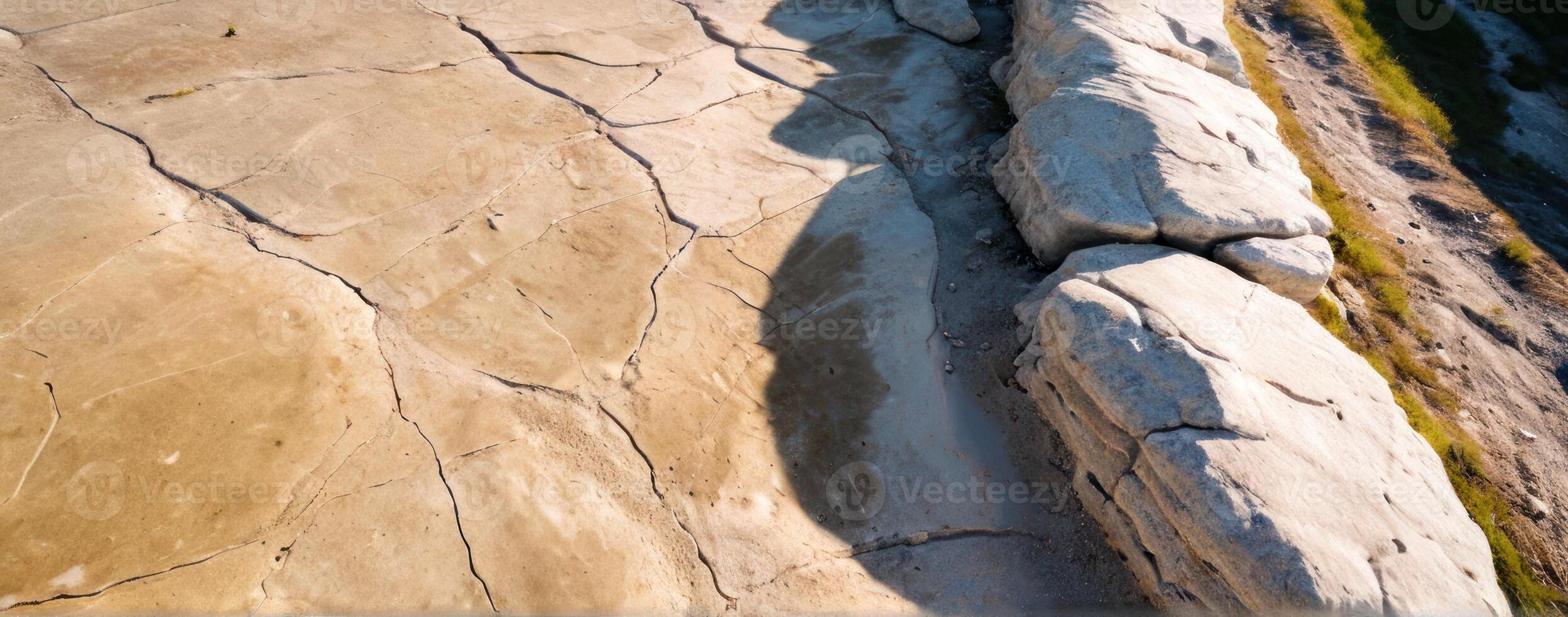 An aerial view of a cliff with rocks on it photo