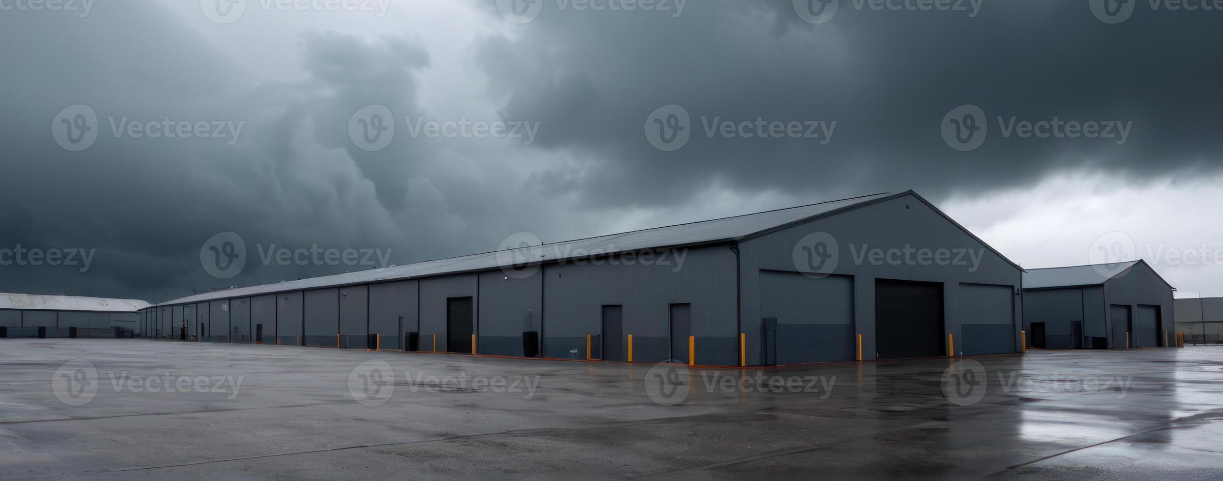 A grey building with dark clouds in the sky photo