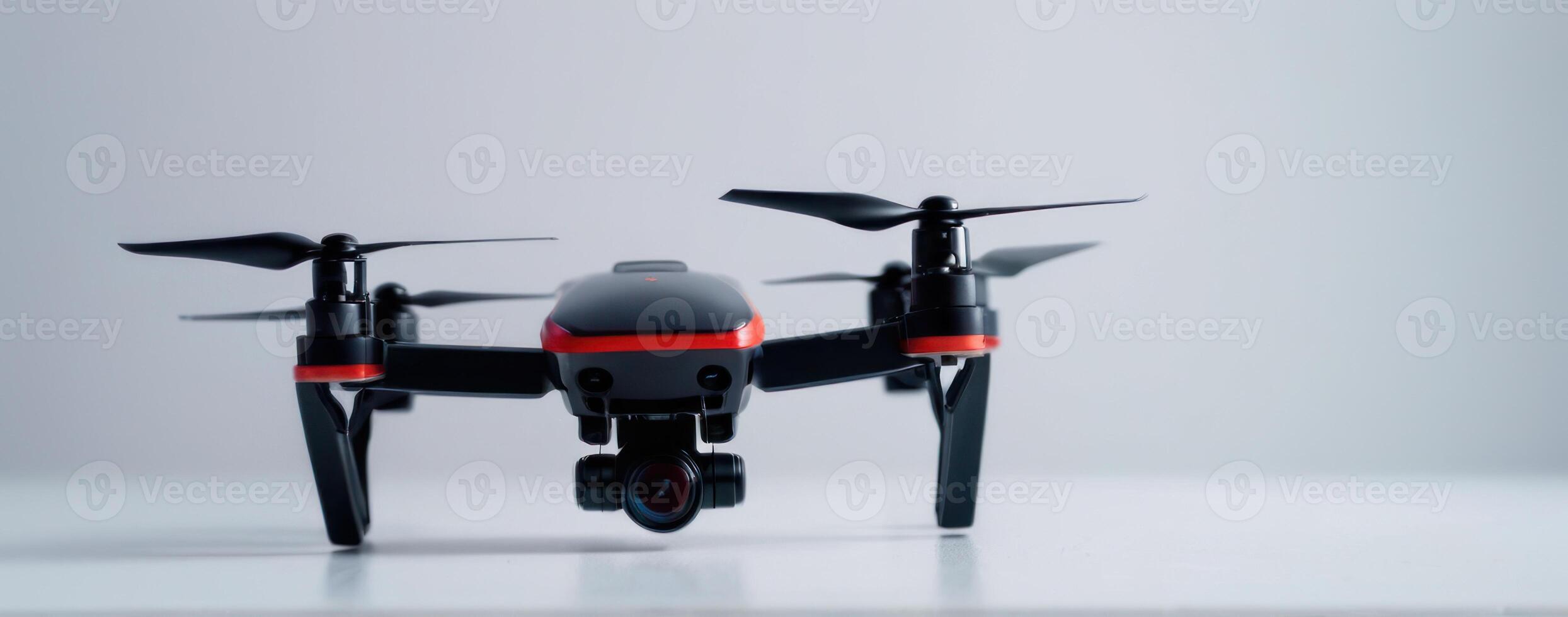 A small black and red drone with propellers photo