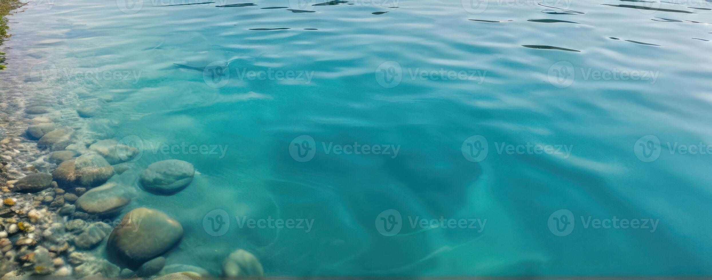 An image of a lake with rocks and clear water photo
