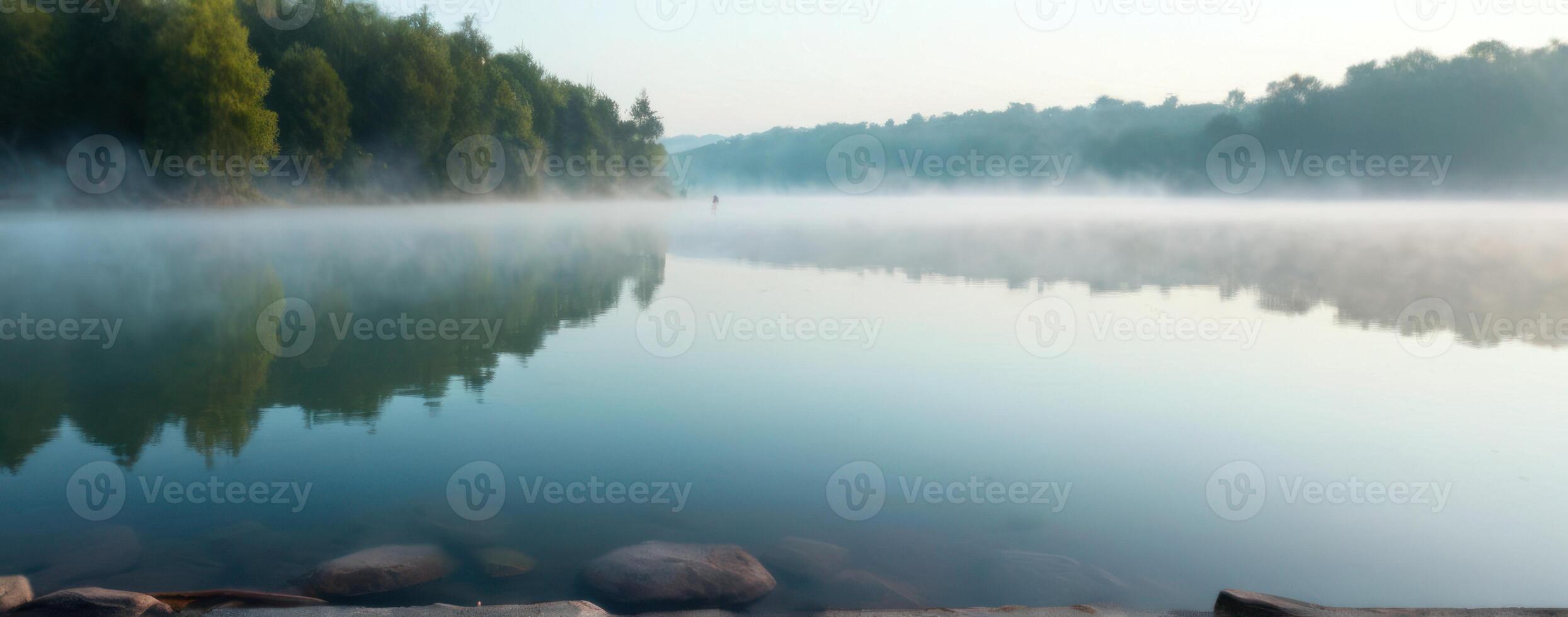 A misty lake surrounded by trees photo