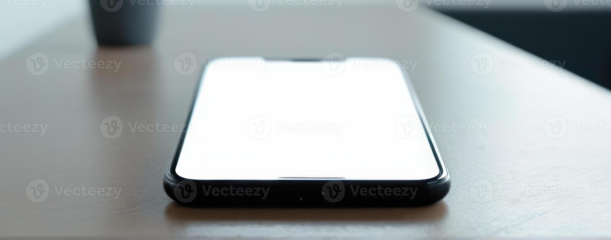 An iphone with a blank screen sitting on the table photo