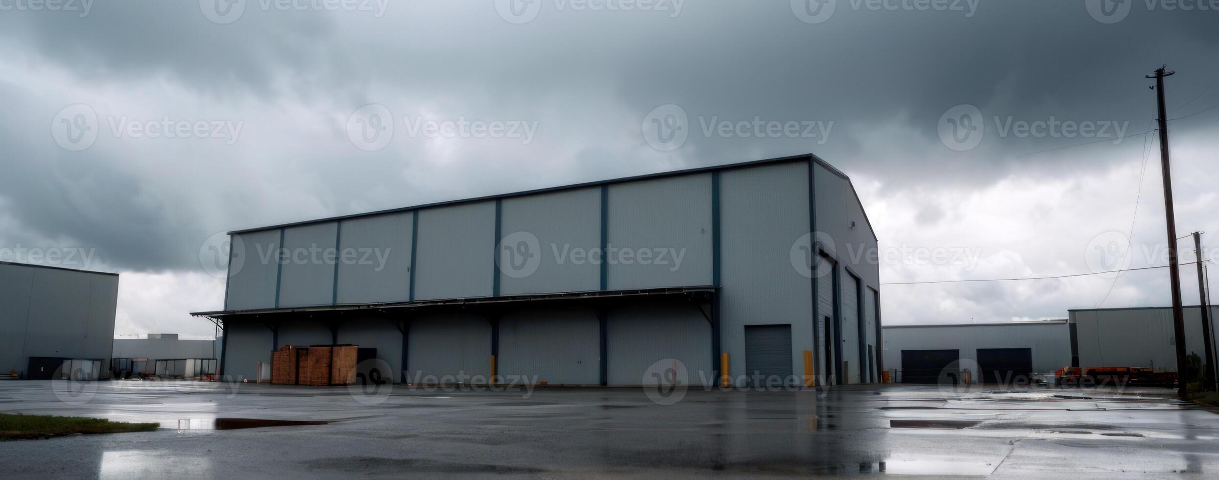 A large warehouse with dark clouds in the sky photo