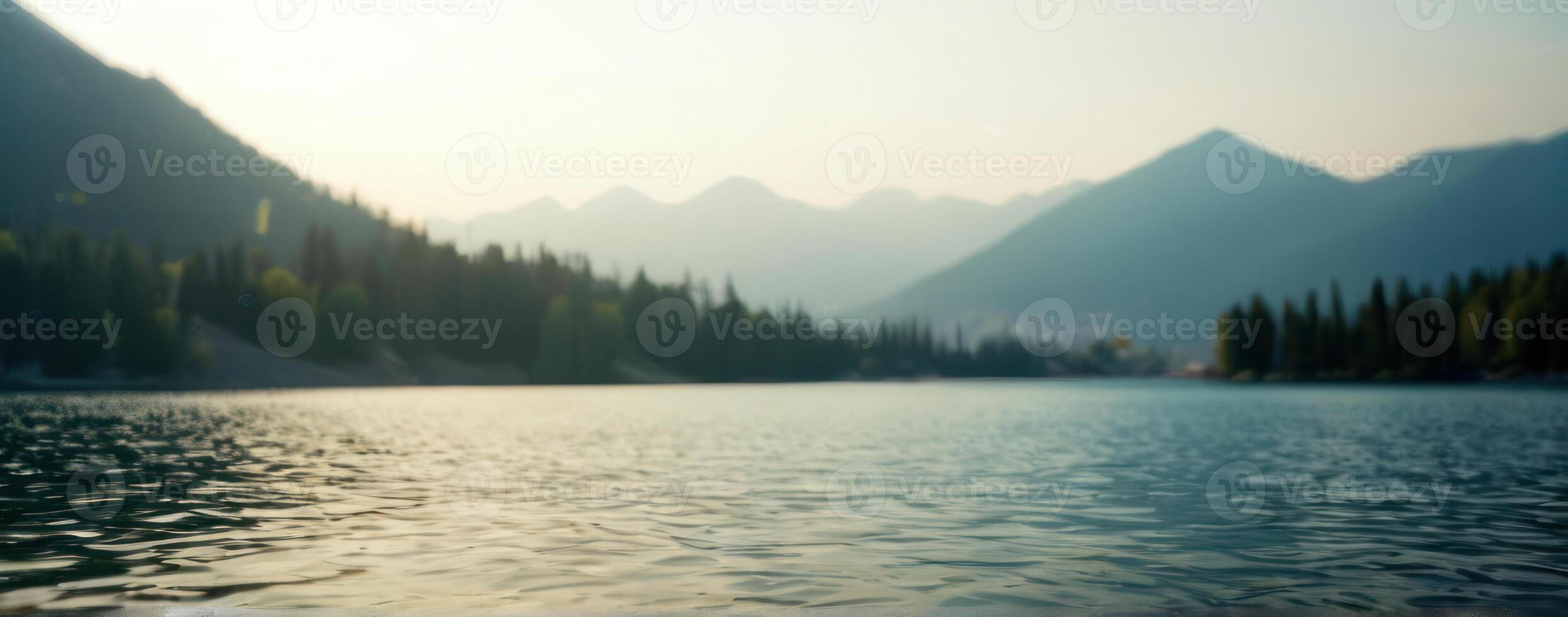 A lake with trees and mountains in the background photo