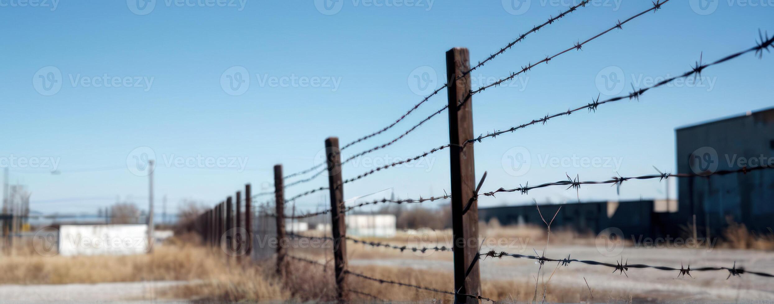 A fence with barbed wire in the background photo