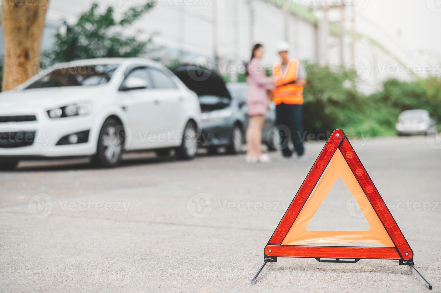 red emergency triangle on the road indicates that there is an accident or car breakdown on the road ahead. photo