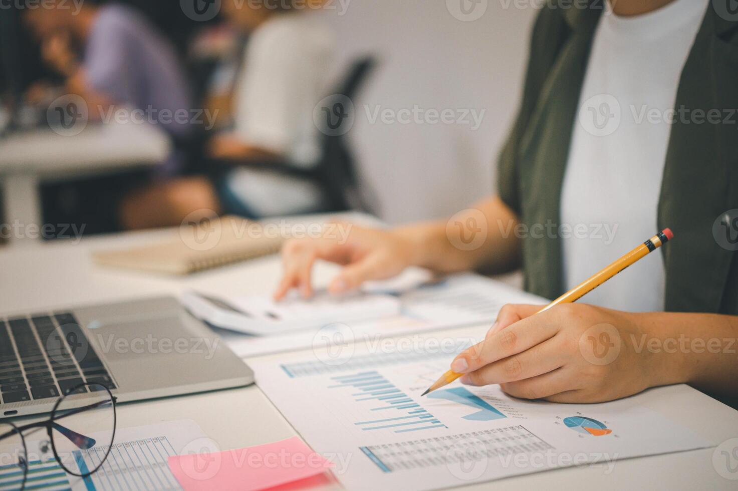 Freelance worker working on documents with graphs. and information about finances on laptops in cafes photo