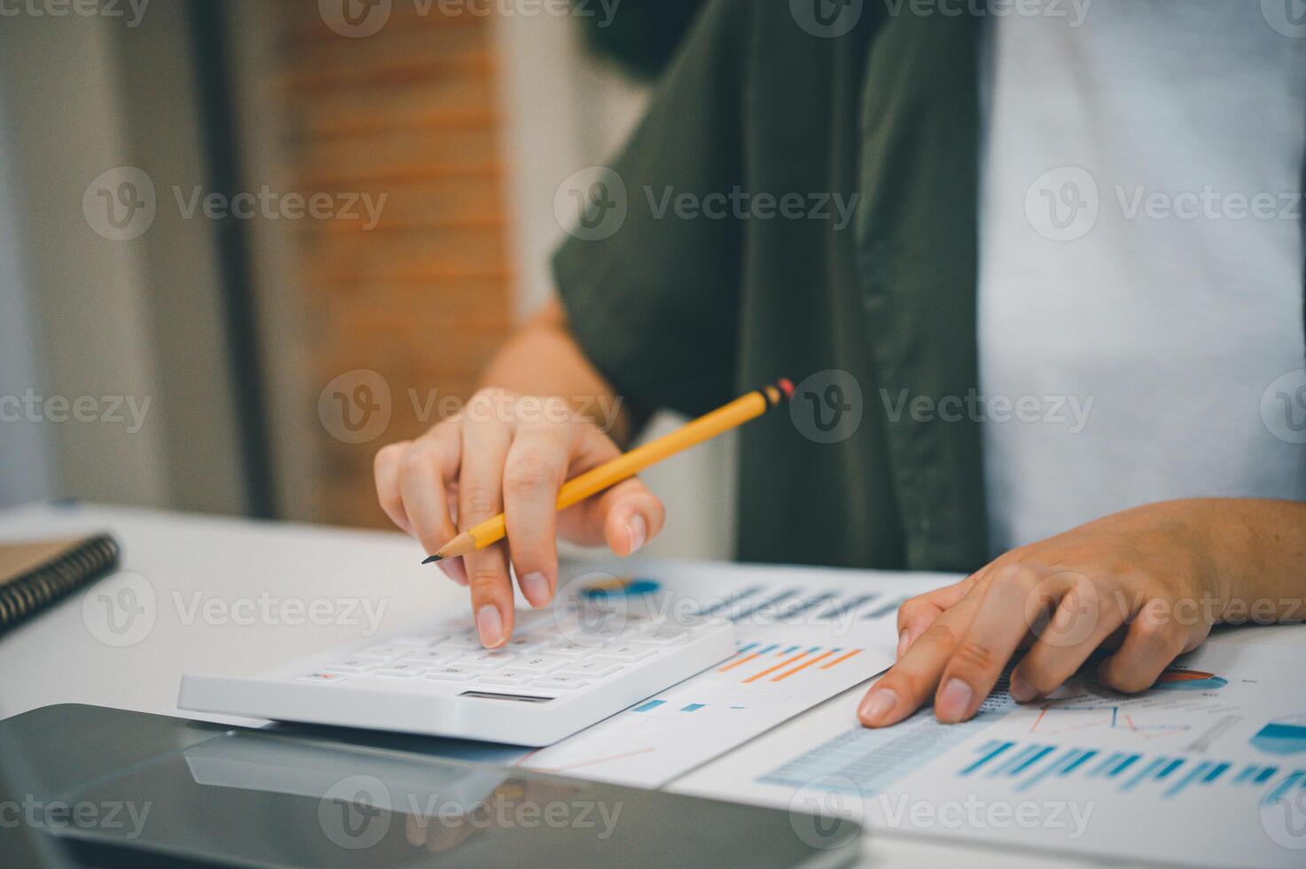 Freelance worker working on documents with graphs. and information about finances on laptops in cafes photo