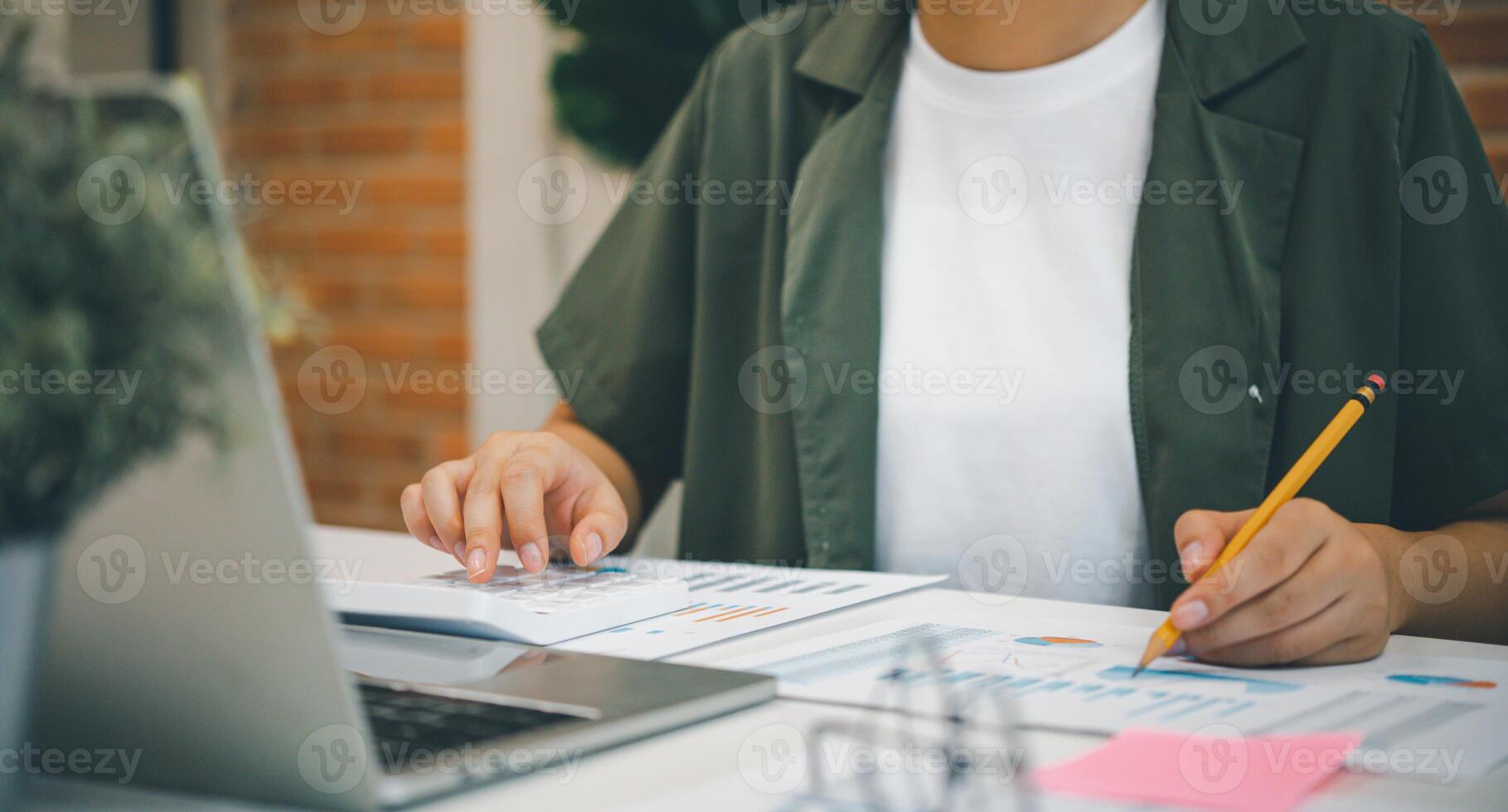 Freelance worker working on documents with graphs. and information about finances on laptops in cafes photo
