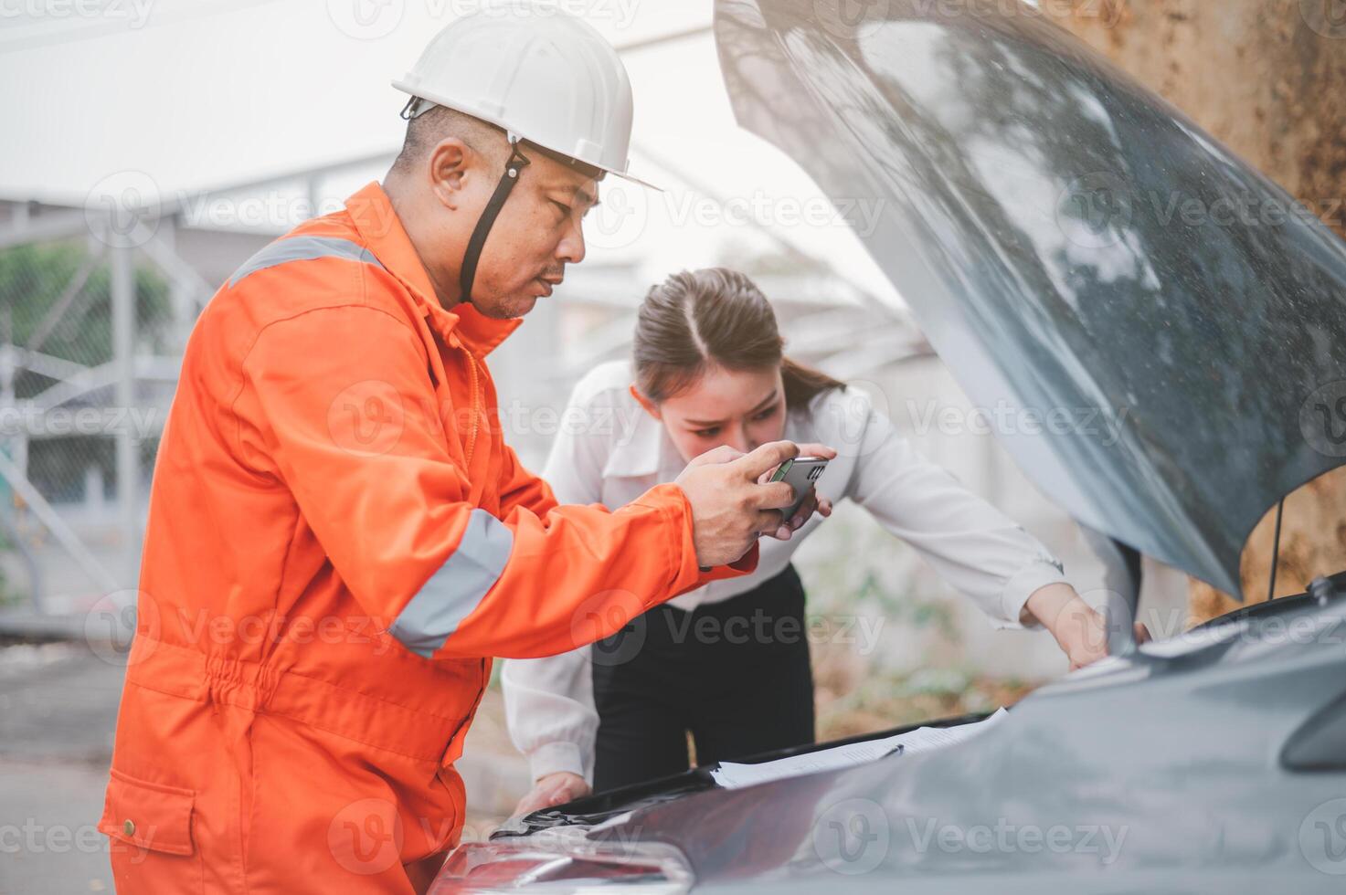 male insurance officer came to help inspect a customer's car that had an accident. Concept for vehicle crash, insurance claim. photo