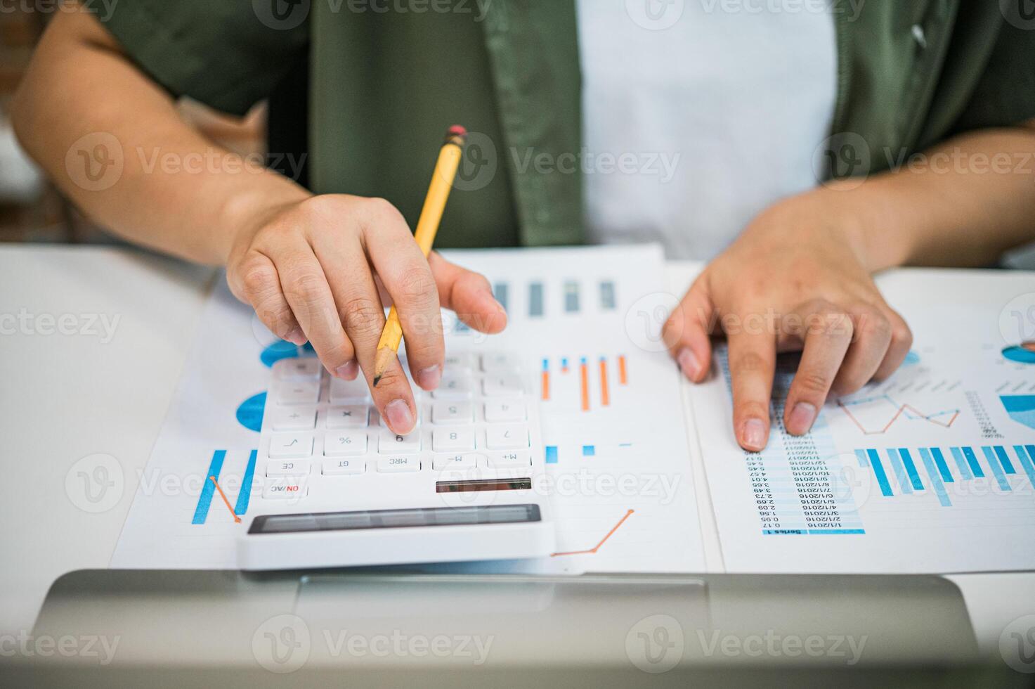 Freelance worker working on documents with graphs. and information about finances on laptops in cafes photo