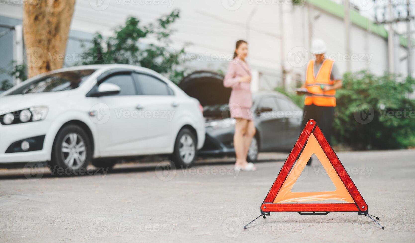 red emergency triangle on the road indicates that there is an accident or car breakdown on the road ahead. photo