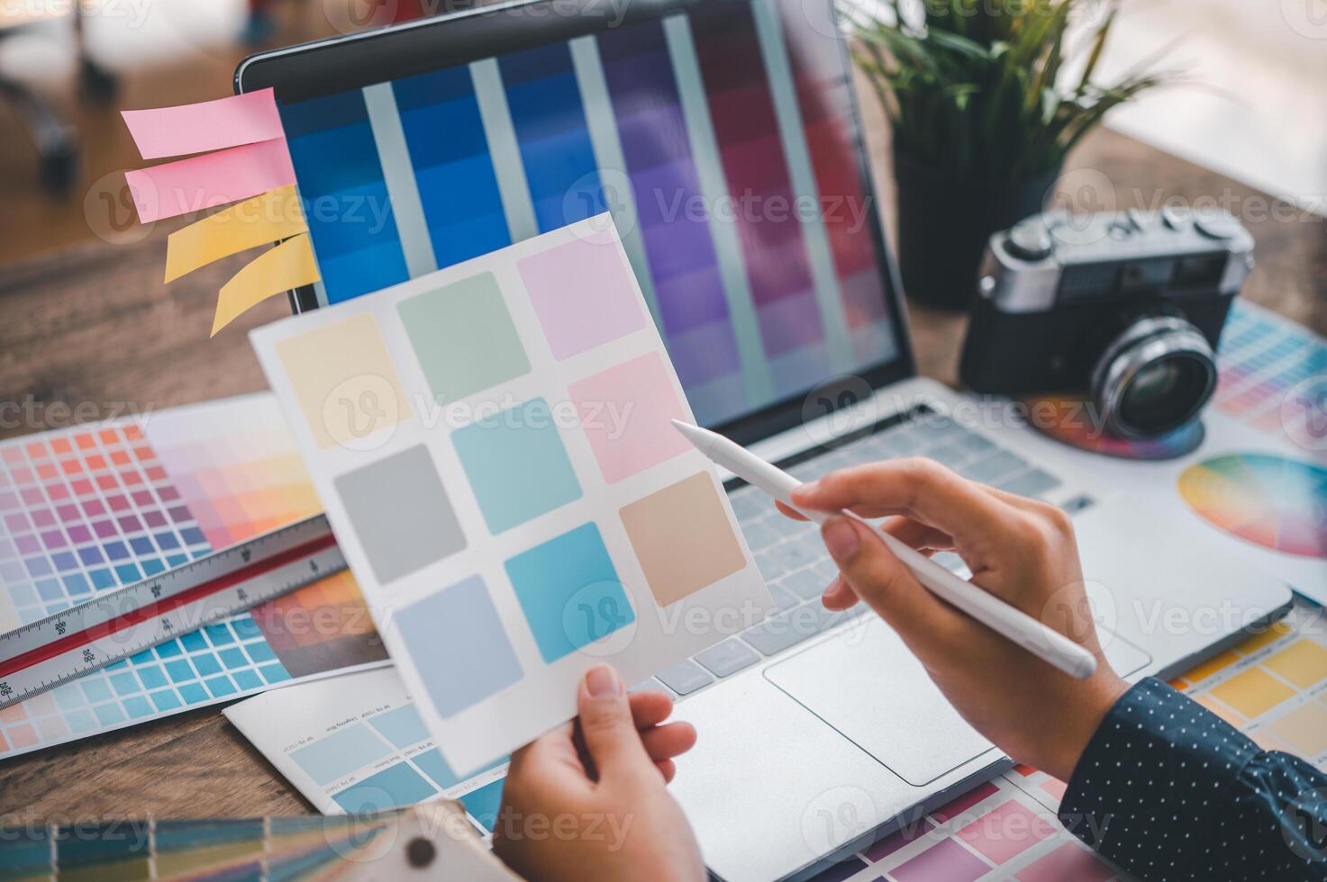 Graphic designer architects who work with laptops and color comparison tables for design work. photo