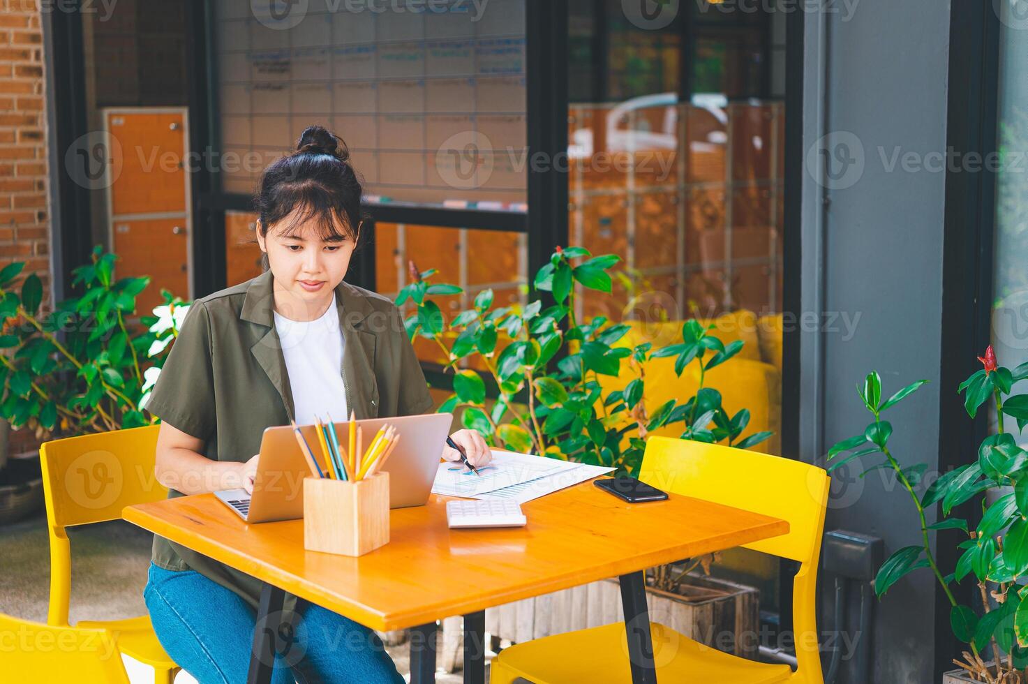 Freelance worker working on documents with graphs. and information about finances on laptops in cafes photo
