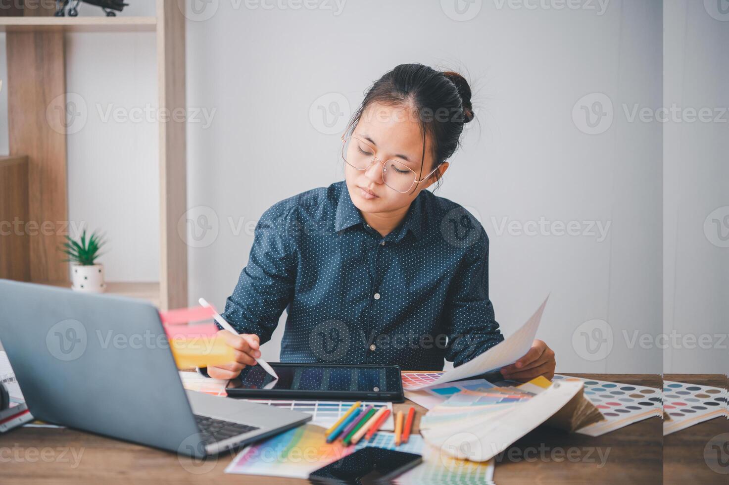 Graphic designer architects who work with laptops and color comparison tables for design work. photo