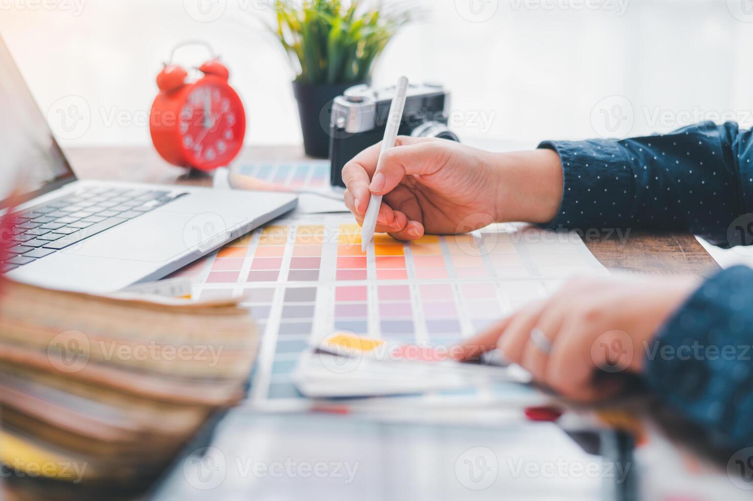 Graphic designer architects who work with laptops and color comparison tables for design work. photo