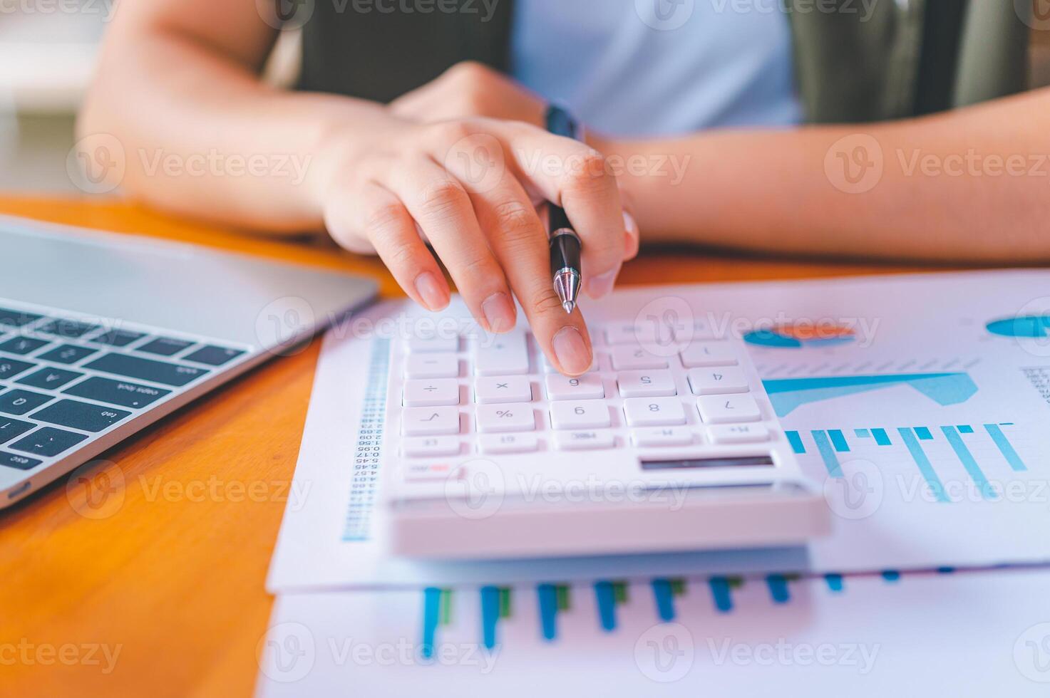 business person sitting at a desk at an office By using the calculator to work. Business Concept Analysis and Planning photo
