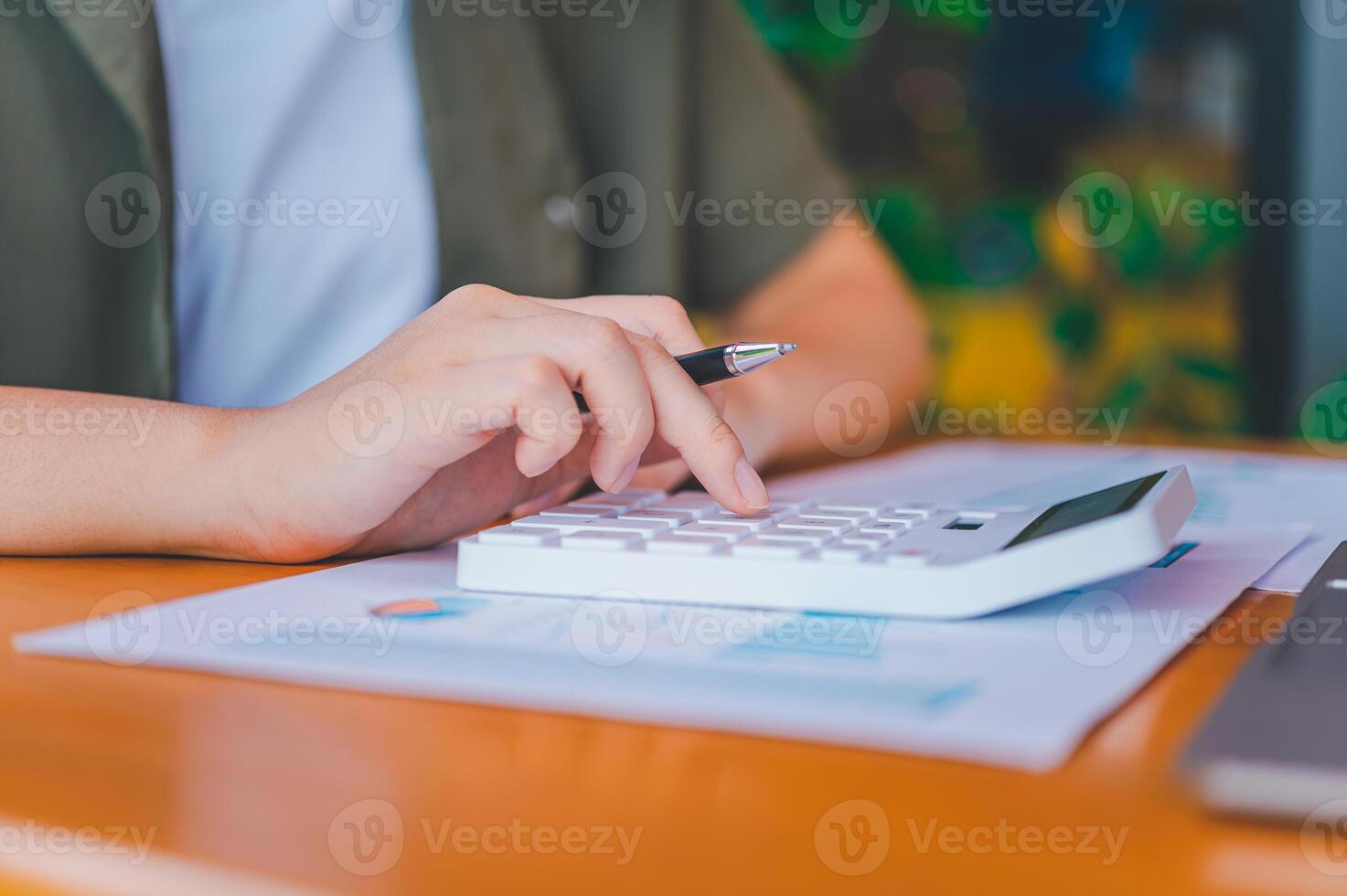 business person sitting at a desk at an office By using the calculator to work. Business Concept Analysis and Planning photo