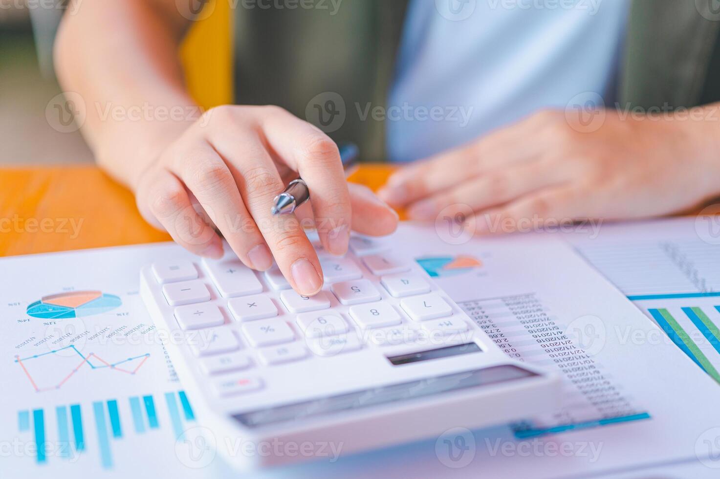 business person sitting at a desk at an office By using the calculator to work. Business Concept Analysis and Planning photo