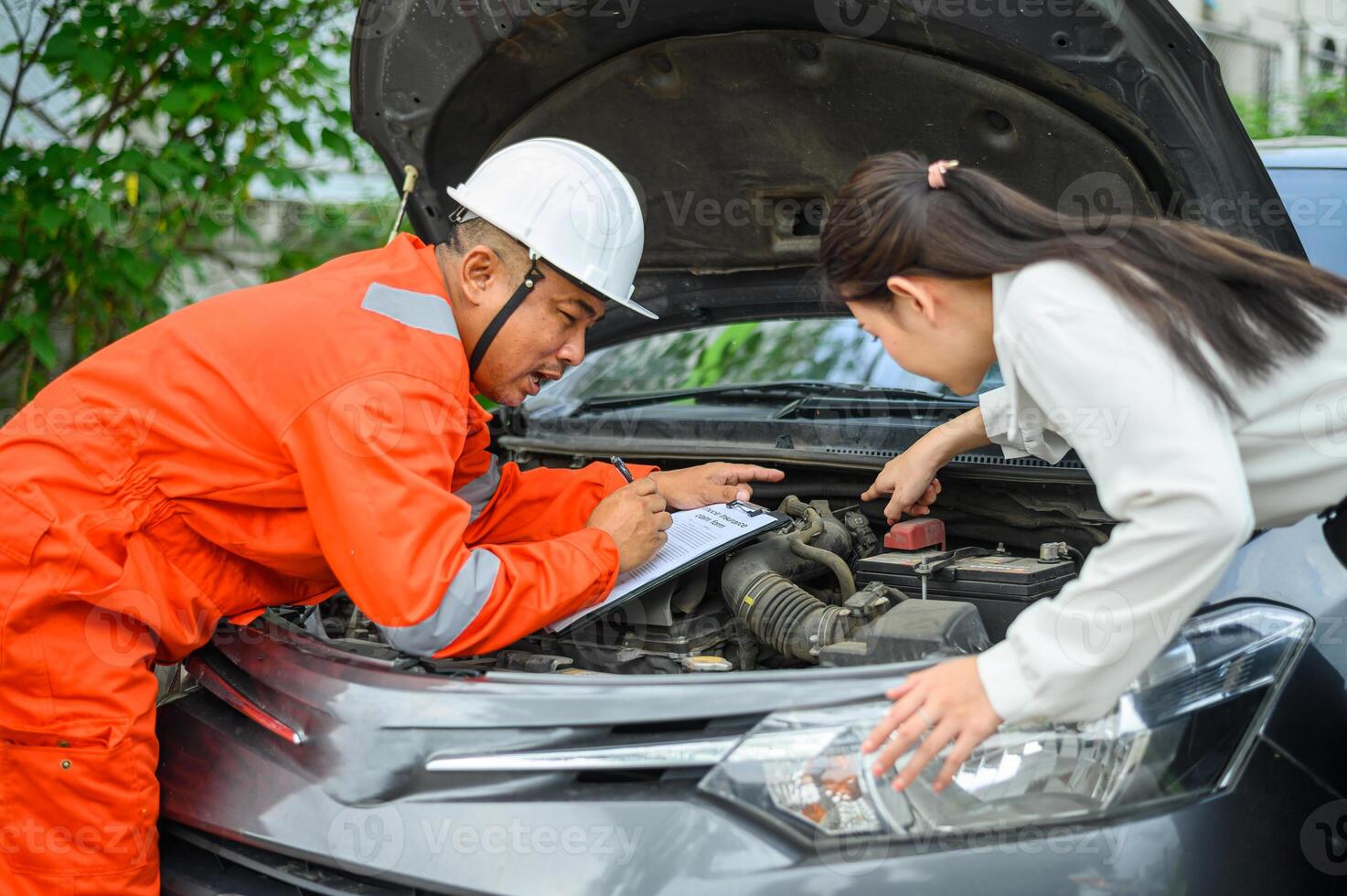 male insurance officer came to help inspect a customer's car that had an accident. Concept for vehicle crash, insurance claim. photo