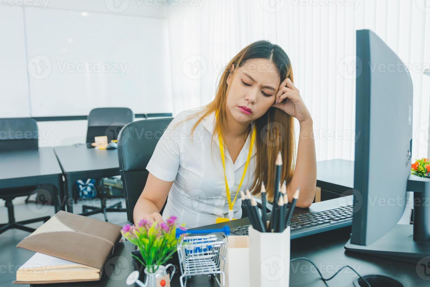 Female office worker is stressed and thoughtful in encountering problems during work. photo