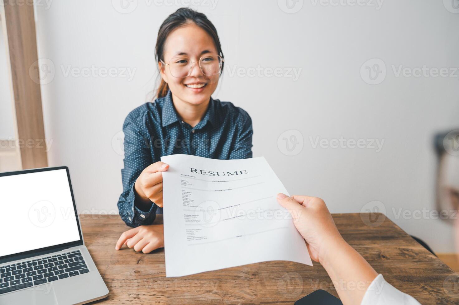 HR managers are interviewing job applicants who fill out their resume on the job application form in order to consider accepting a job as a company photo