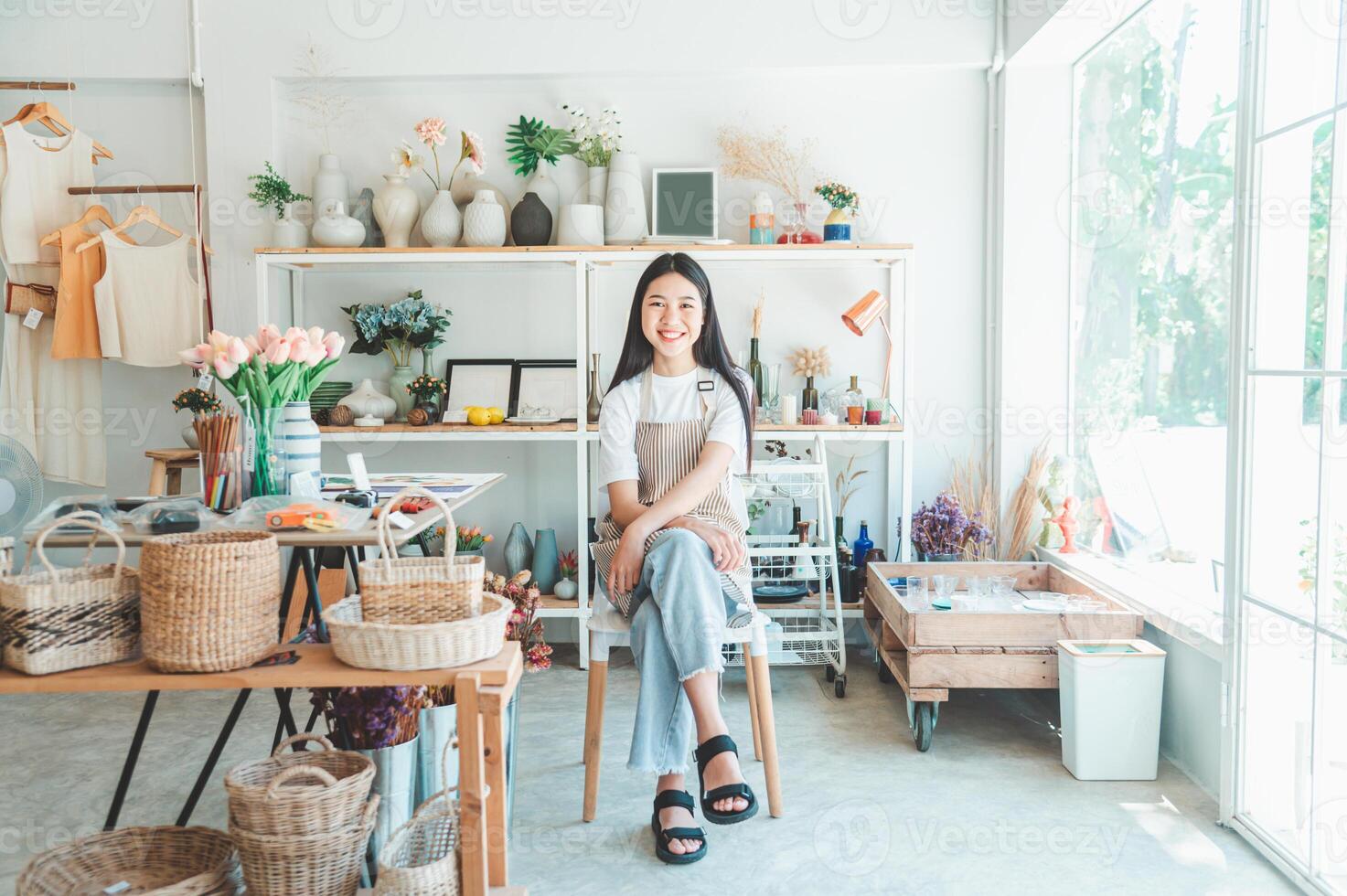 Small business owners pose smiling in their small shop to welcome customers and get customers online. And check the orders that customers have ordered of online retailers - online shopping. photo