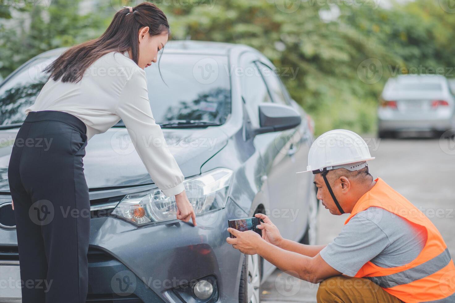 male insurance officer came to help inspect a customer's car that had an accident. Concept for vehicle crash, insurance claim. photo