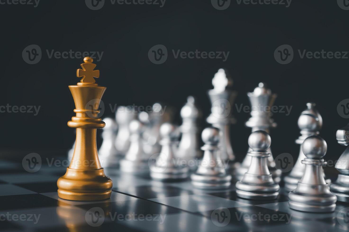 King golden chess standing confront of the silver chess team.chess board game concept of business ideas and competition and stratagy plan success meaning photo