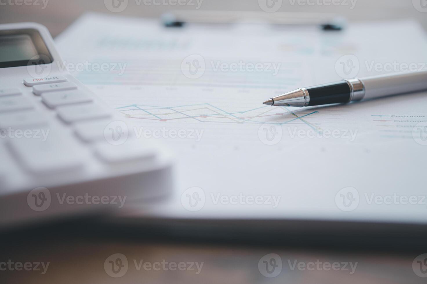 Close-up of financial figures with a calculator and a pen .financial and accounting concept photo