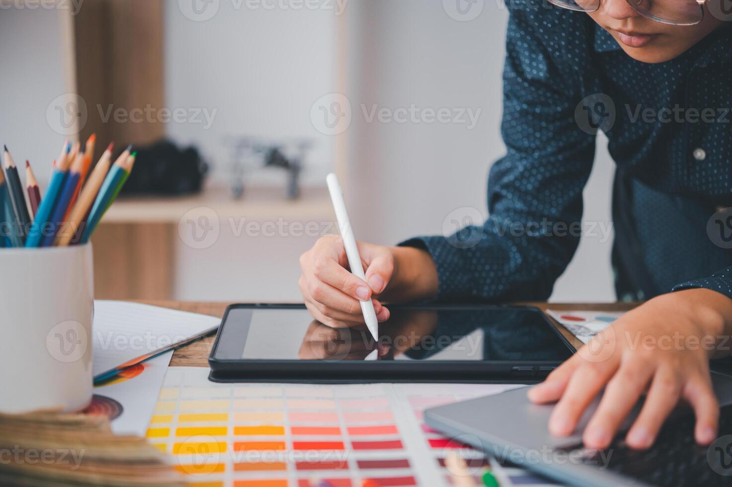 Graphic designer architects who work with laptops and color comparison tables for design work. photo