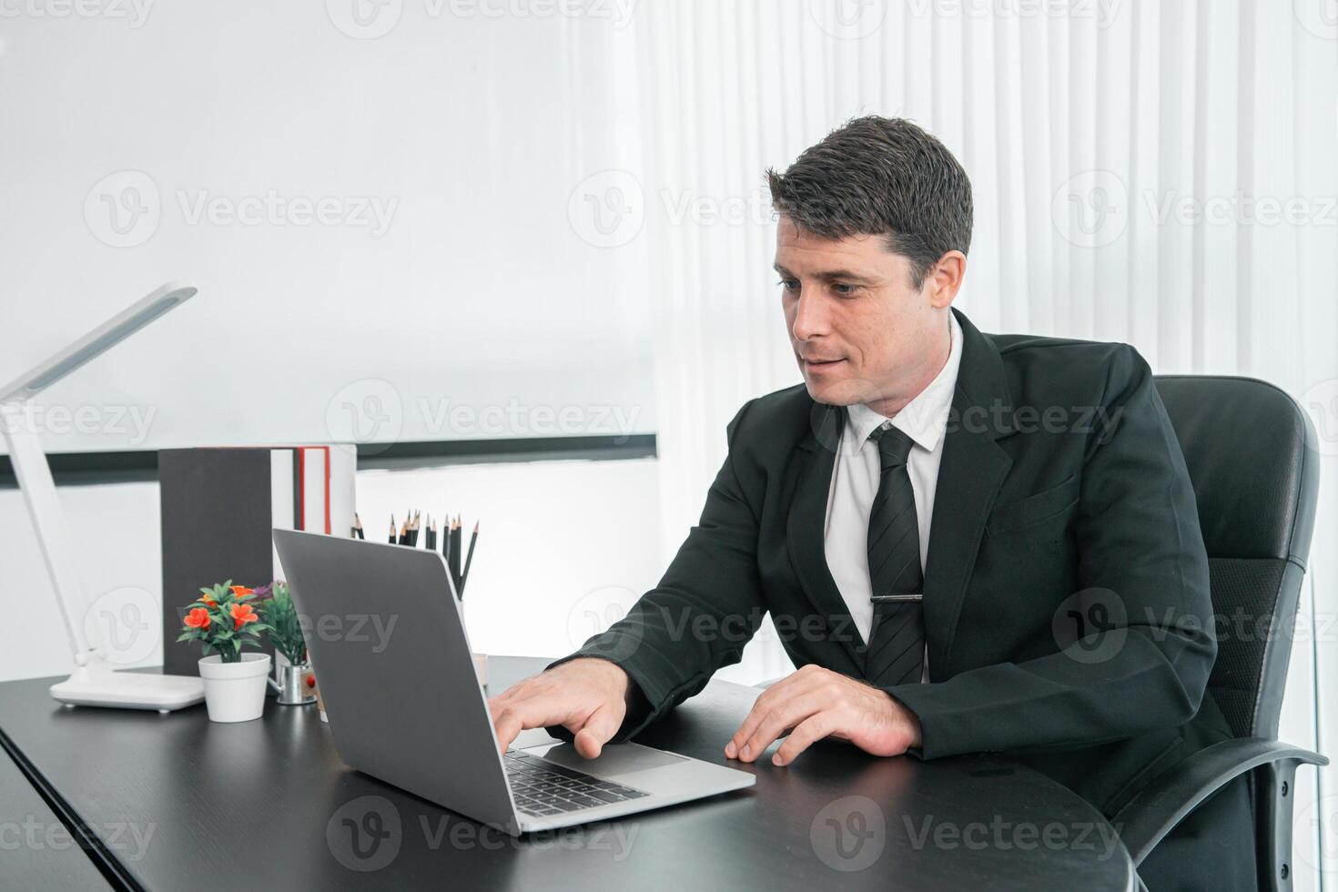 businessman sitting at worktable at modern office analyzing company performance, finance and investment photo