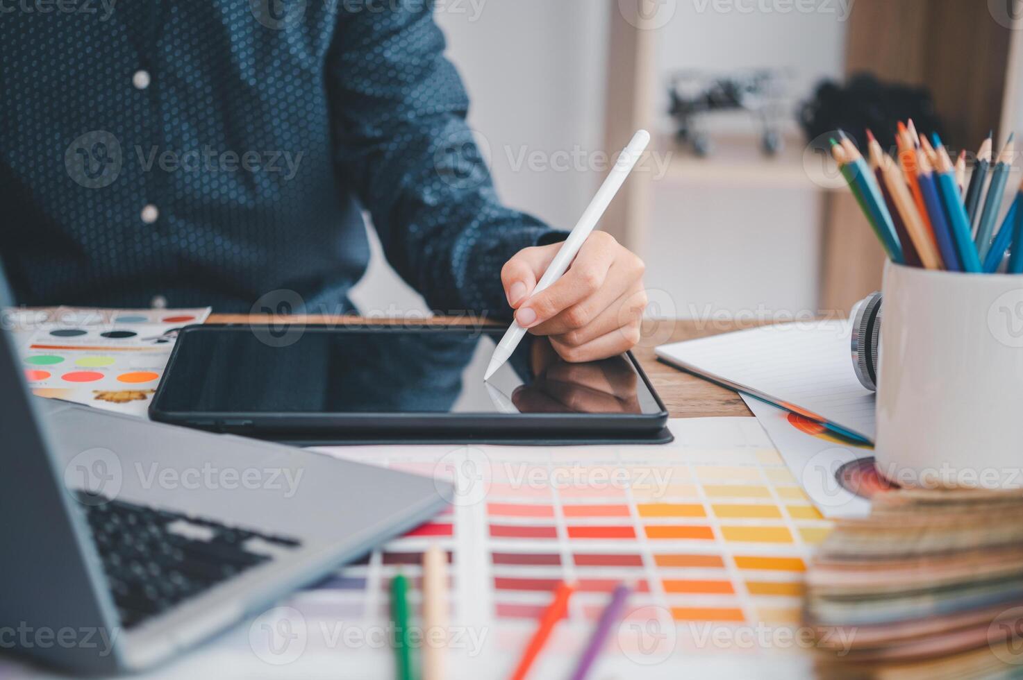 Graphic designer architects who work with laptops and color comparison tables for design work. photo