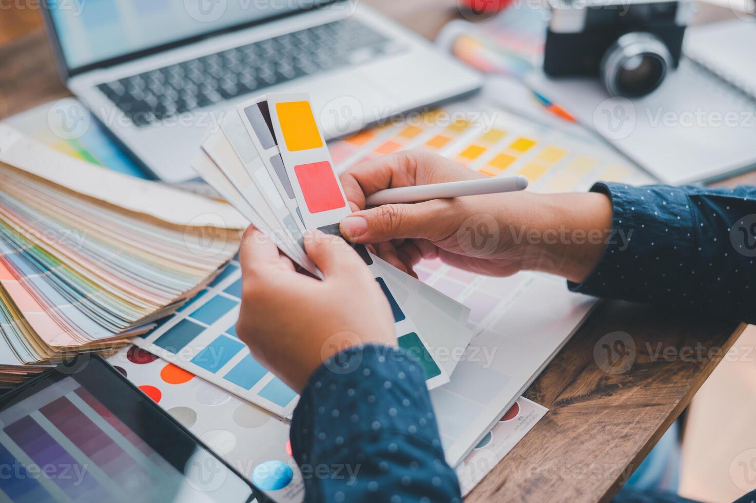 Graphic designer architects who work with laptops and color comparison tables for design work. photo