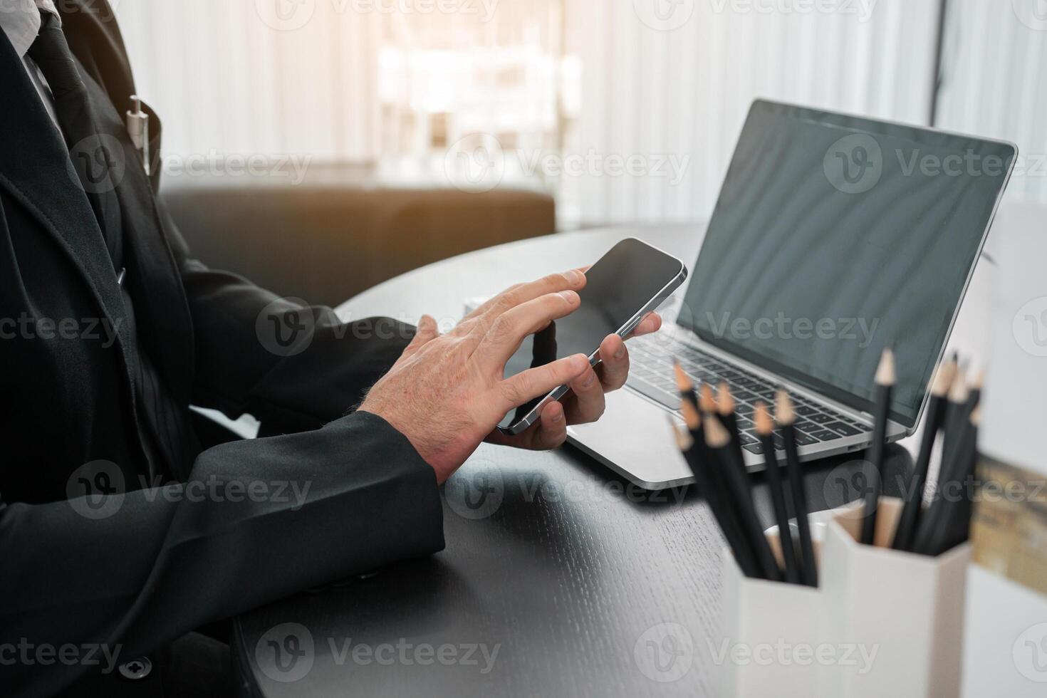 Businessman working on the phone touching the screen, browsing the internet or writing text messages. photo