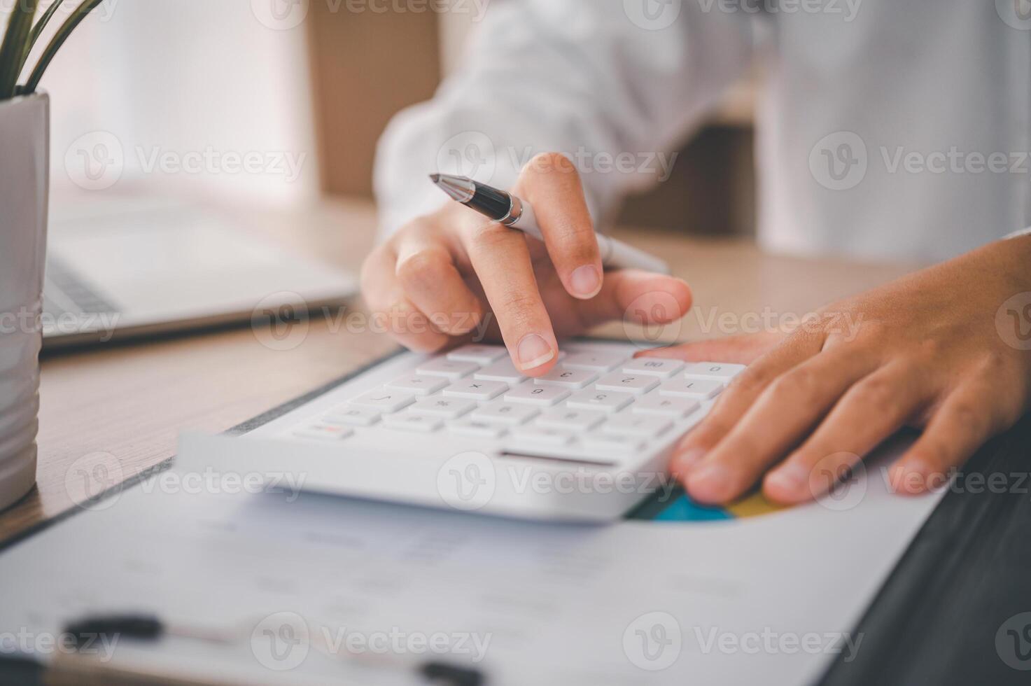 close up The business person is sitting on a calculator with a graph in the office of finance accounting concept photo