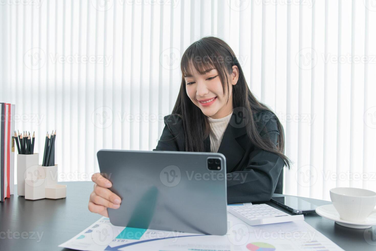 business woman working on the tablet ,discussing customer and checking business analytic document report working place in office. photo