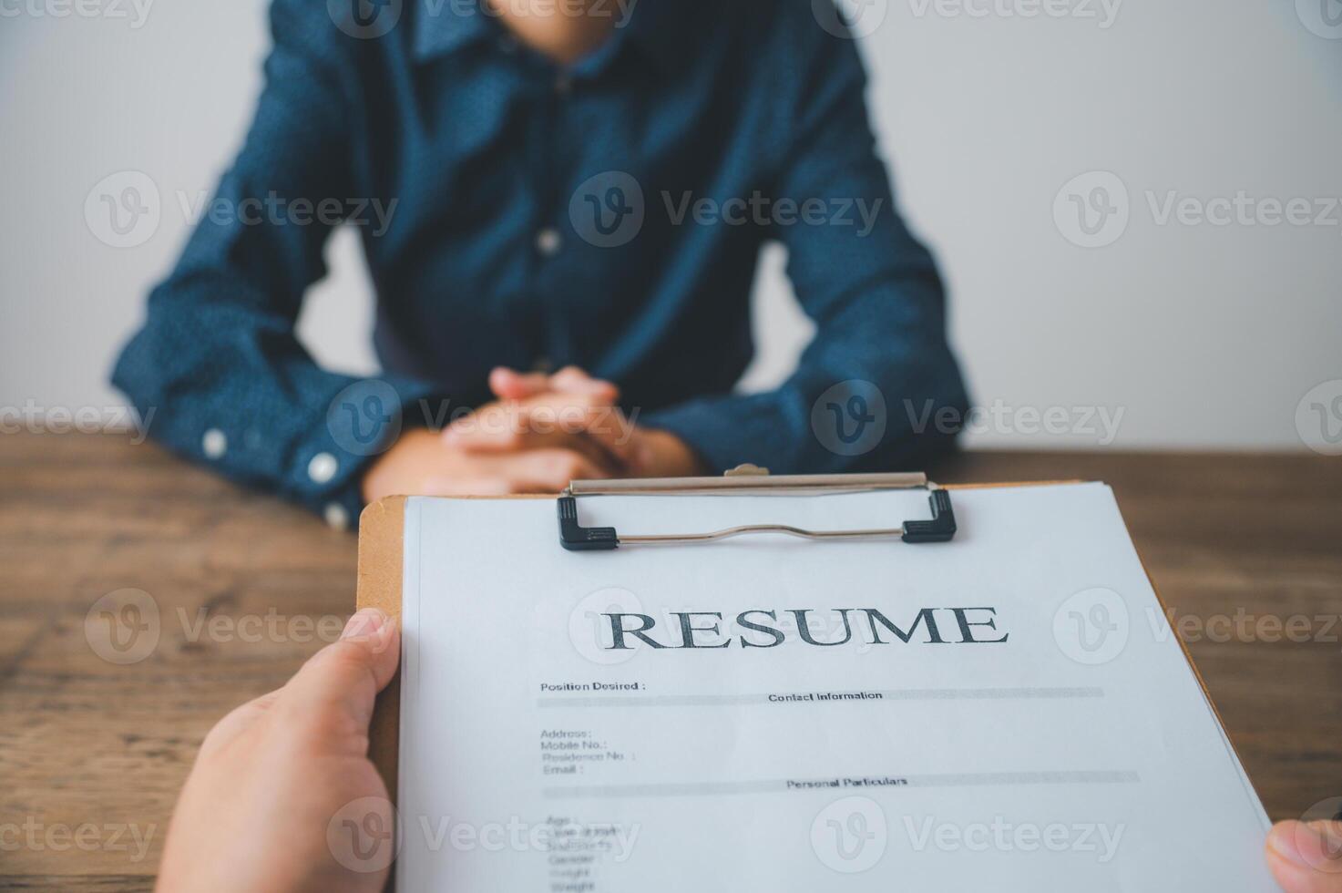 HR managers are interviewing job applicants who fill out their resume on the job application form in order to consider accepting a job as a company photo