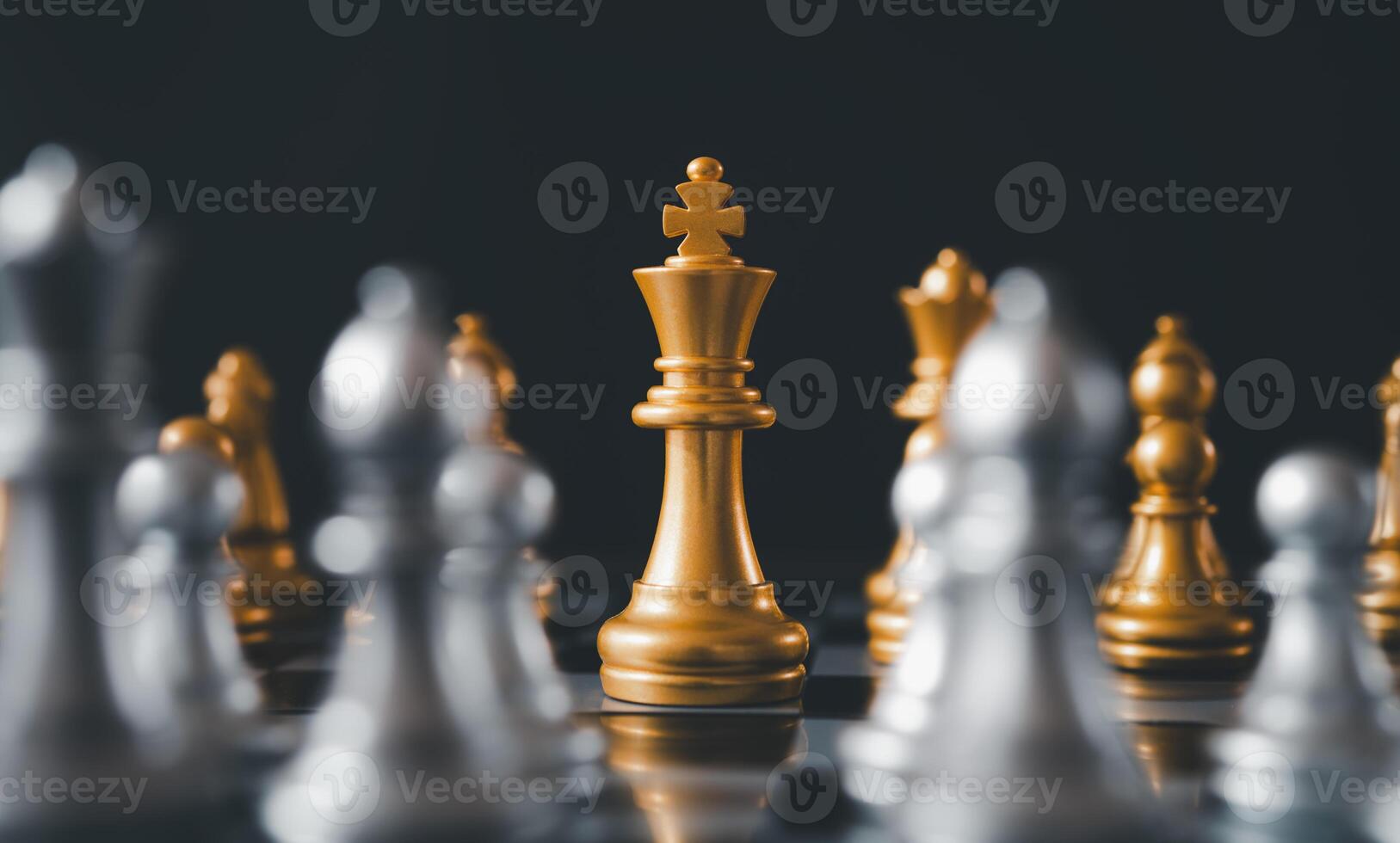 King golden chess standing confront of the silver chess team.chess board game concept of business ideas and competition and stratagy plan success meaning photo