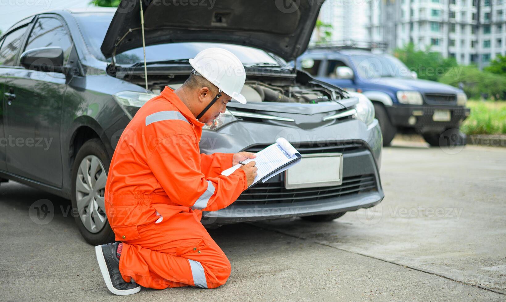 male insurance officer came to help inspect a customer's car that had an accident. Concept for vehicle crash, insurance claim. photo