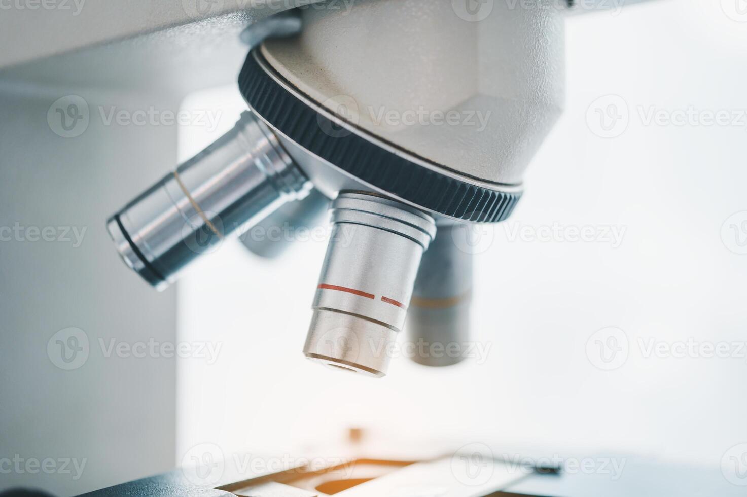 Female researchers are experimenting with pipette dropping a sample into a test tube in an experiment research in laboratory.. photo