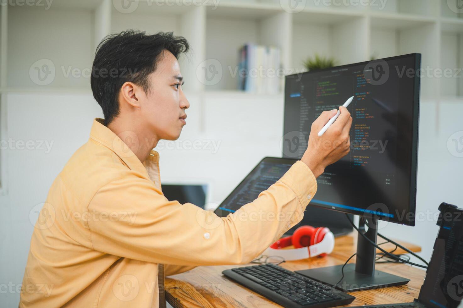Young programmer working on coding, software development and web design in software company office.Concept technology development photo