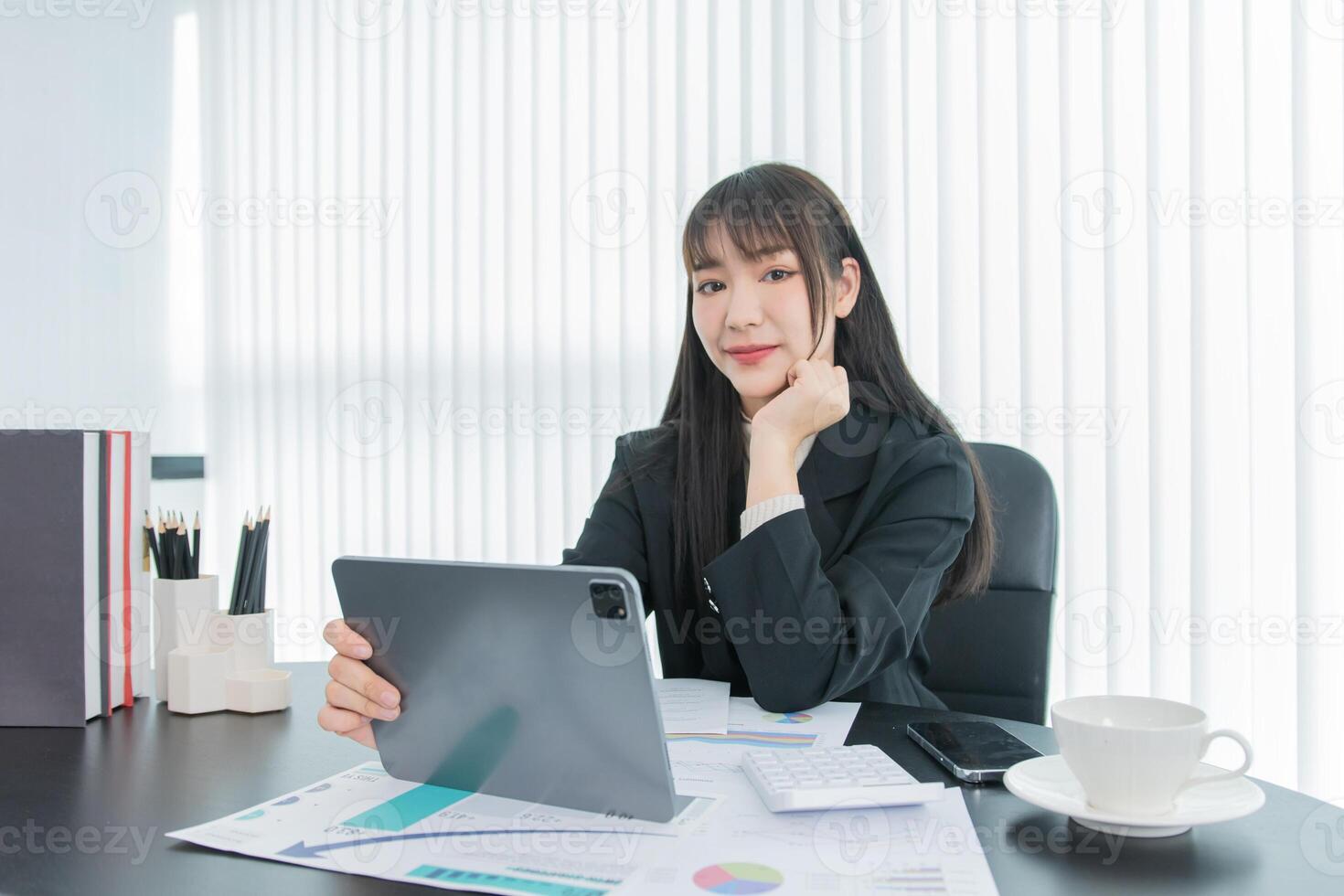 business woman working on the tablet ,discussing customer and checking business analytic document report working place in office. photo