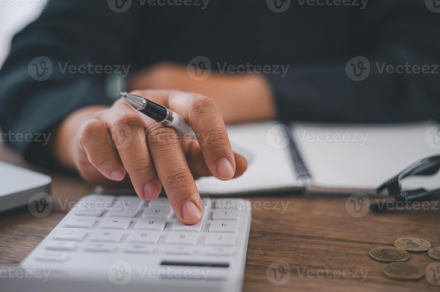 close up The business person is sitting on a calculator with a graph in the office of finance accounting concept photo