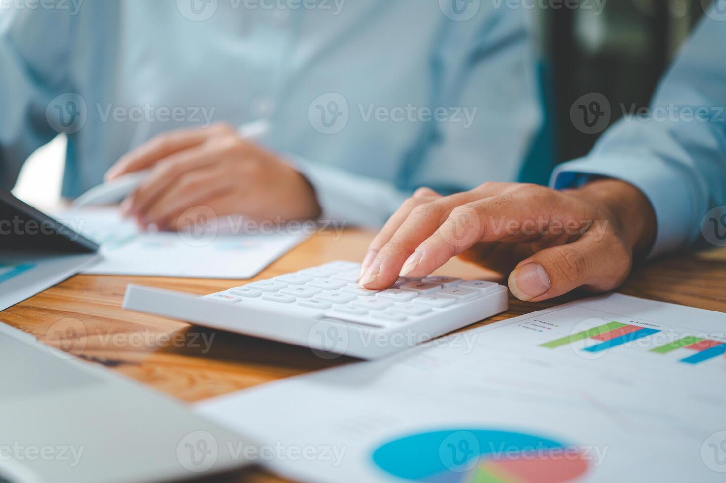 close up The business person is sitting on a calculator with a graph in the office of finance accounting concept photo