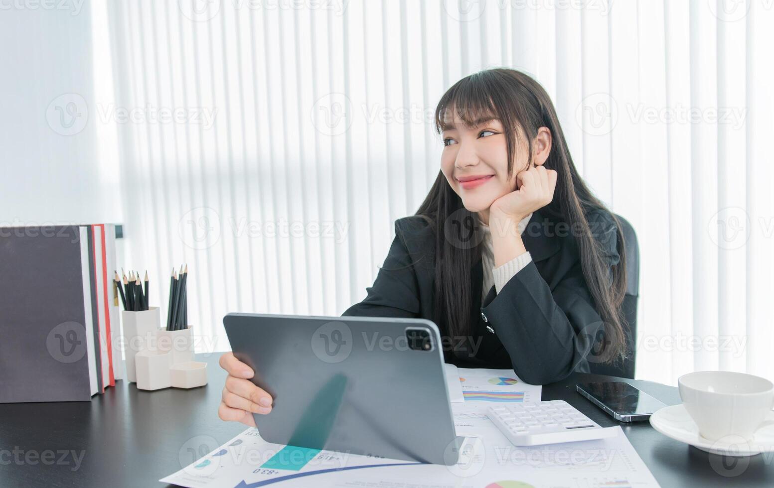 business woman working on the tablet ,discussing customer and checking business analytic document report working place in office. photo