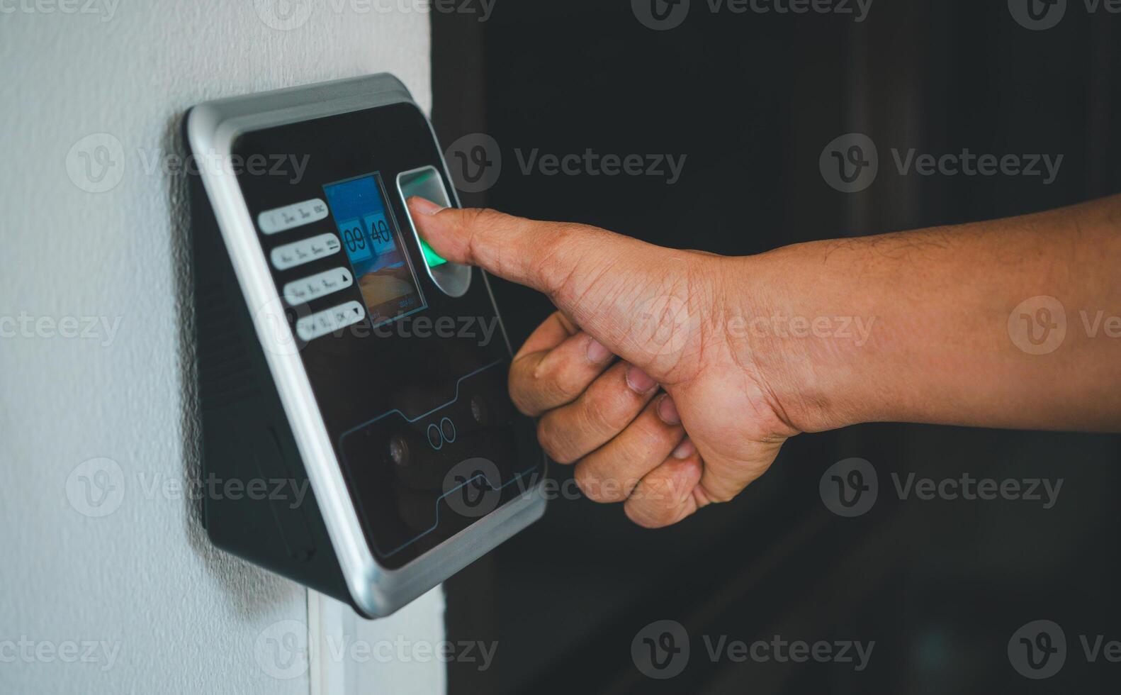 A person is using a fingerprint reader to access a building photo