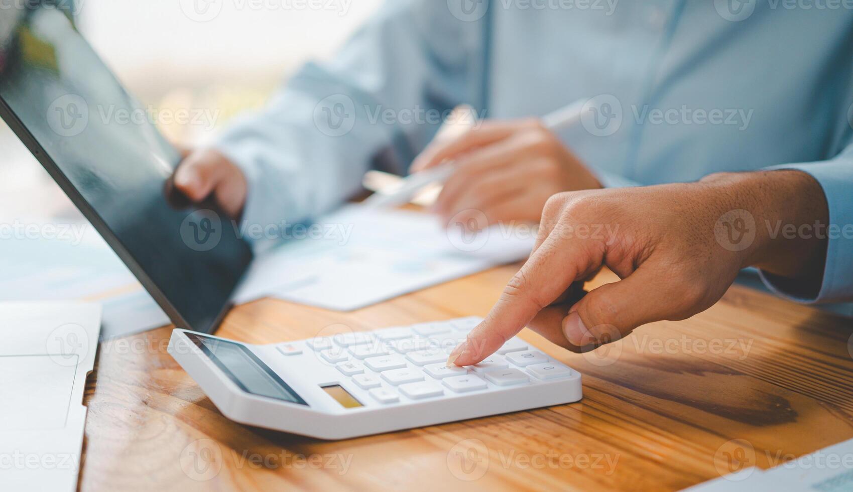 close up The business person is sitting on a calculator with a graph in the office of finance accounting concept photo