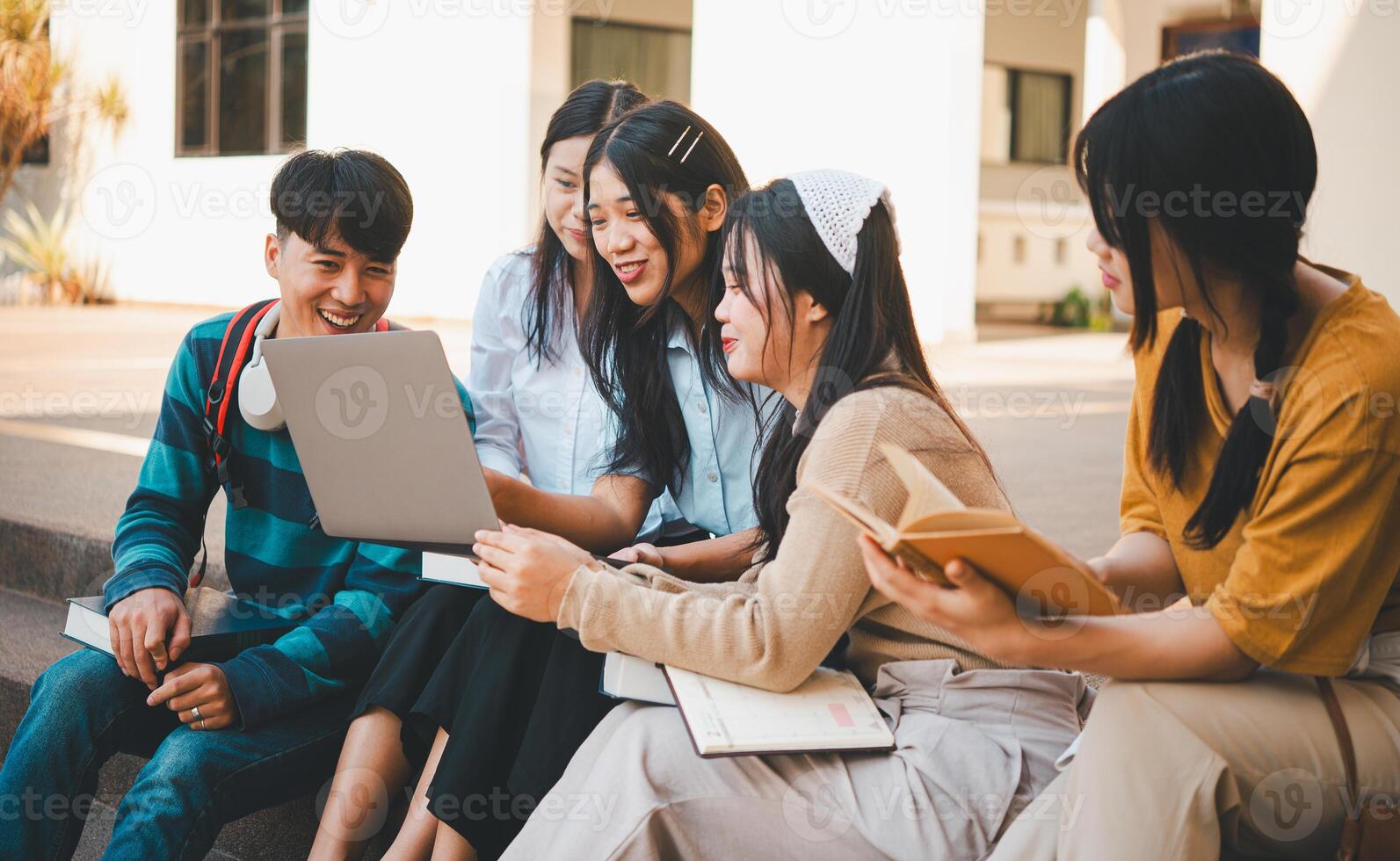 group of students young university students consulting doing homework, cooperating research plan Discuss concepts and strategies. Prepare presentations on laptops and tablet computers. photo