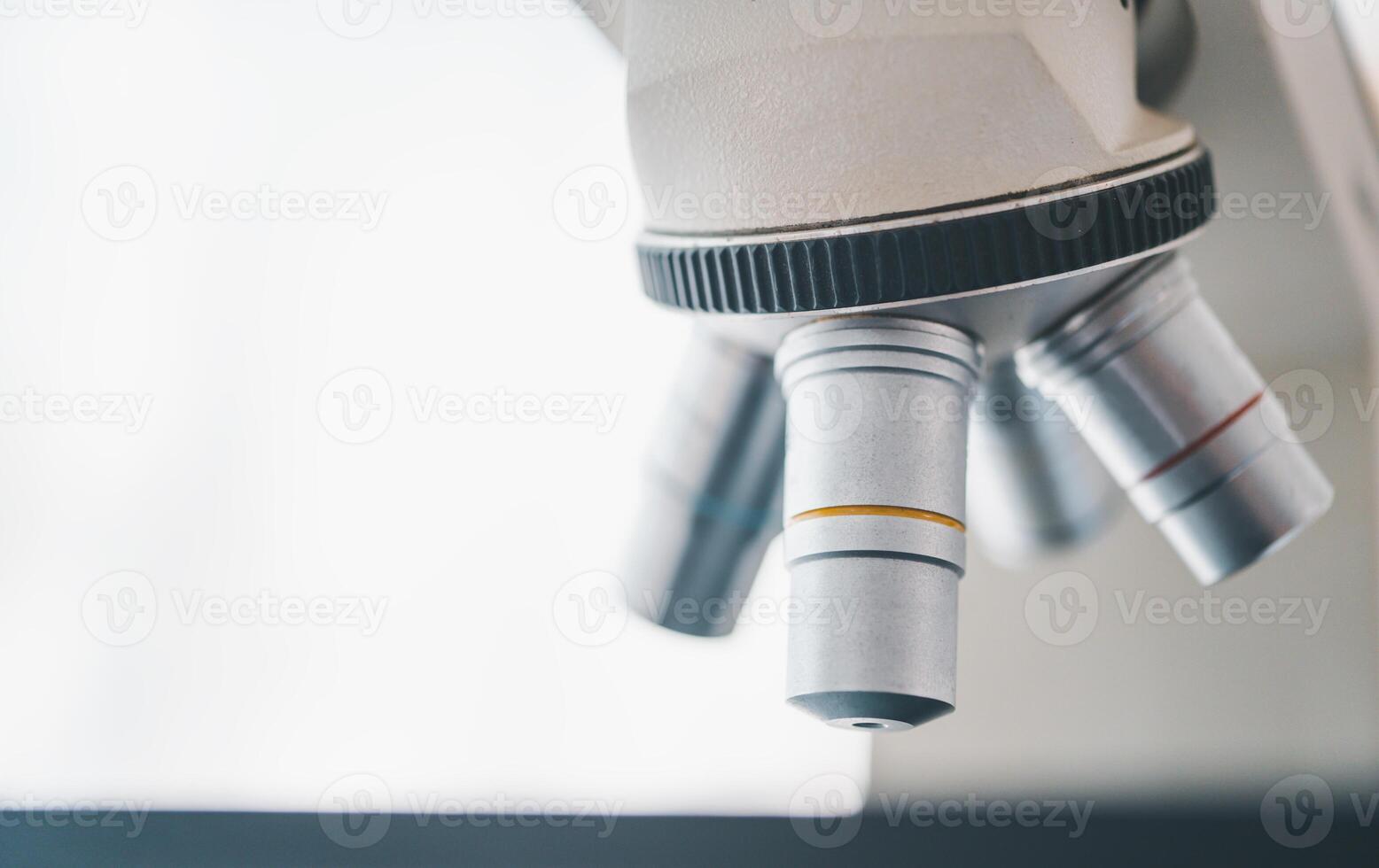 Female researchers are experimenting with pipette dropping a sample into a test tube in an experiment research in laboratory.. photo